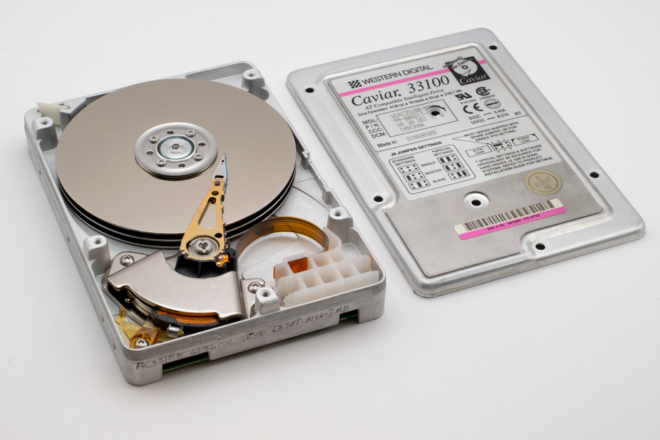 Old Western Digital hard drive open, showing platters and circuit board.