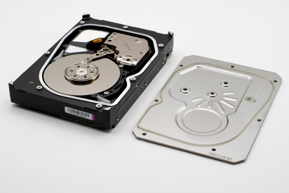 Detailed view of an open hard drive showing the internal discs and cover plate.