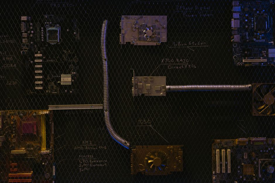 Artistic arrangement of circuit boards and cables symbolizes modern technology.